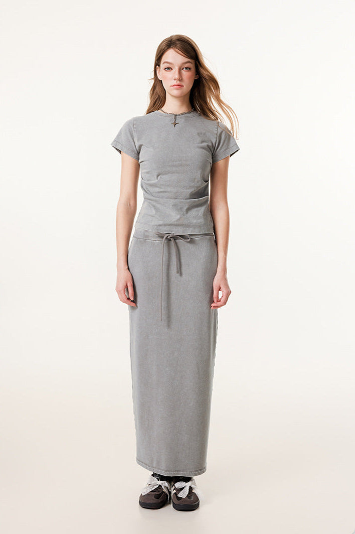 Light gray long denim skirt and matching short-sleeve top with gray and black sneakers with white bow laces