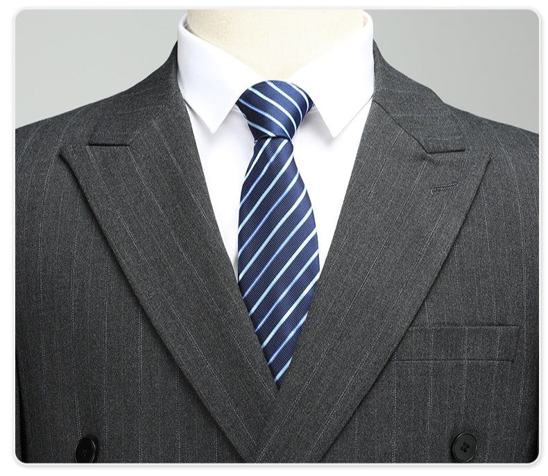 Close-up of suit lapel and navy striped tie, highlighting wool fabric texture and pattern details