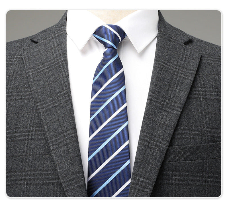 Close-up of suit lapel with white shirt and navy/light blue striped tie showing fabric texture