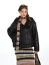 Black leather jacket with fur trim, model styled with printed scarf and sunglasses