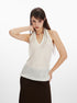 Woman posing in white tank top with V neckline and textured knit design