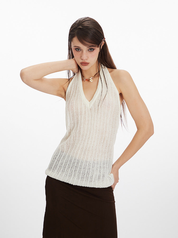 Woman posing in white tank top with V neckline and textured knit design