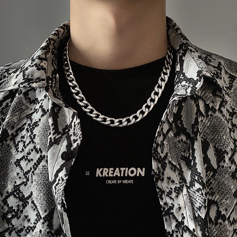 Silver chain necklace styled with black top and printed jacket