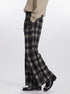 Side view of plaid pants showing full-length wide silhouette with chunky loafers