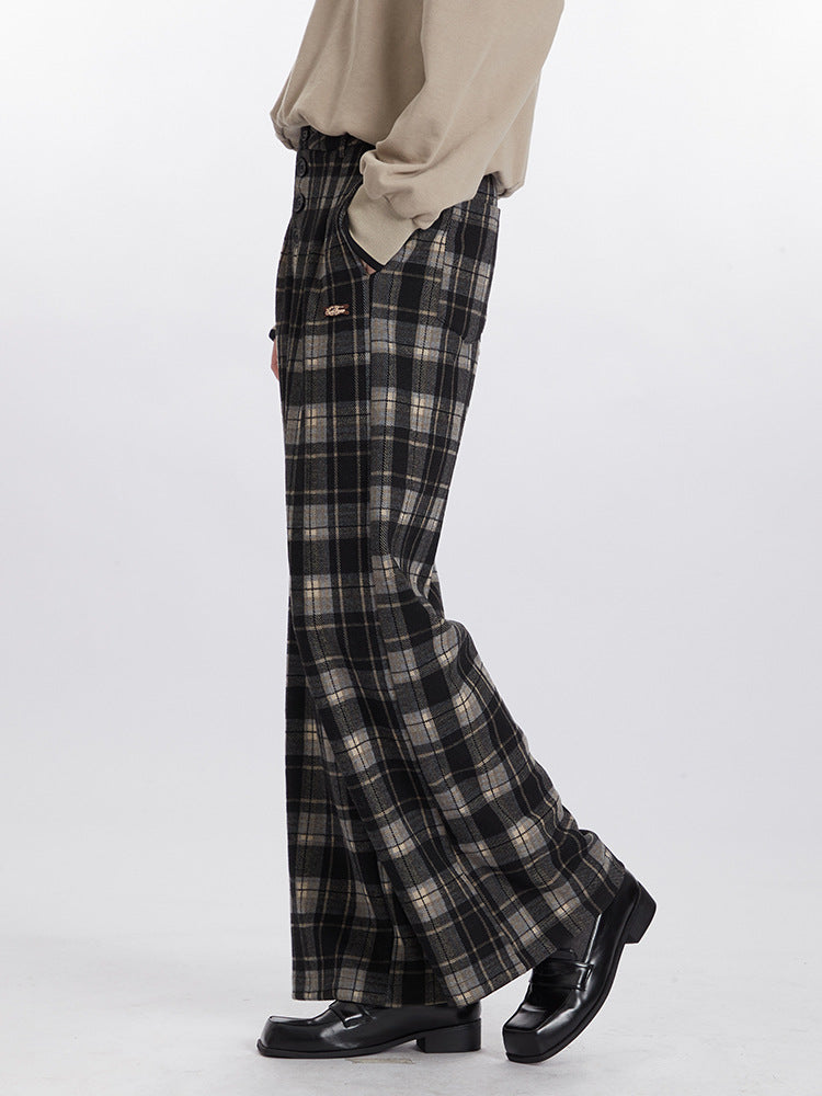 Side view of plaid pants showing full-length wide silhouette with chunky loafers