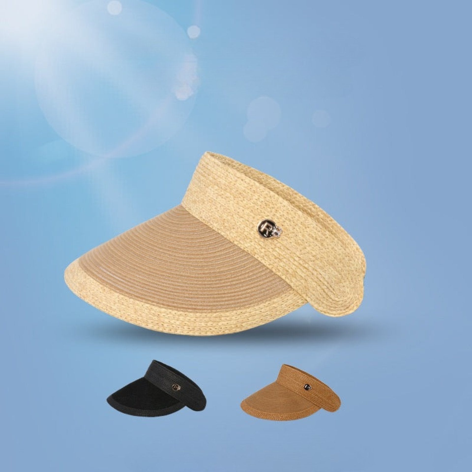A natural straw visor with a wide, curved brim and two other hats under, set against a blue background.