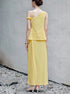 Back view of yellow two piece skirt set with sleeveless one shoulder top