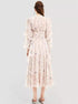 Back view of a woman in a floral maxi dress with a cinched waist and puff sleeves, showcasing the elegant flow of the fabric and delicate floral print