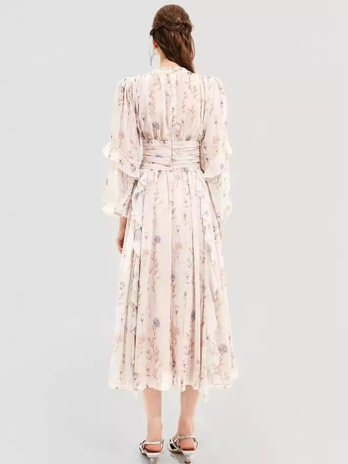 Back view of a woman in a floral maxi dress with a cinched waist and puff sleeves, showcasing the elegant flow of the fabric and delicate floral print