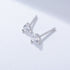Silver three-prong diamond stud earrings with round brilliant cut stones displayed on white background