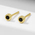 Minimalist gold-plated stud earrings with black nano zirconia stones, front view on white background