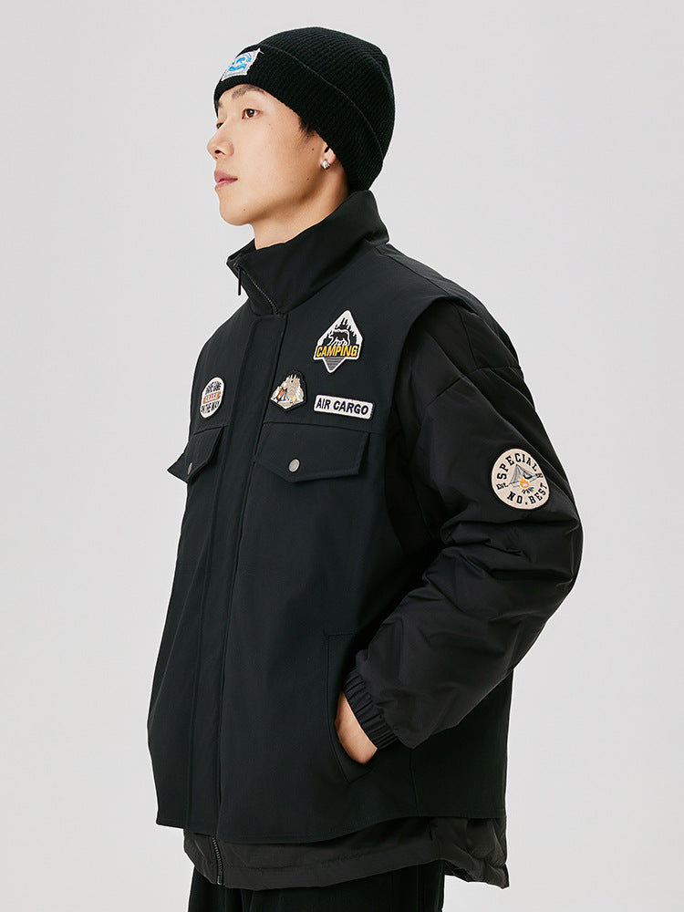 Side view of black military-style jacket with embroidered patches, showing camping logo and special number badge on sleeve