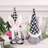 Front and back view of two Easter bunny gnome plush dolls in black-and-white plaid outfits, one holding pink roses and the other a carrot.