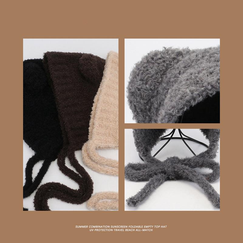 Close-up fabric detail of teddy bear hats showing black, brown and beige textured material alongside gray hat texture on white background