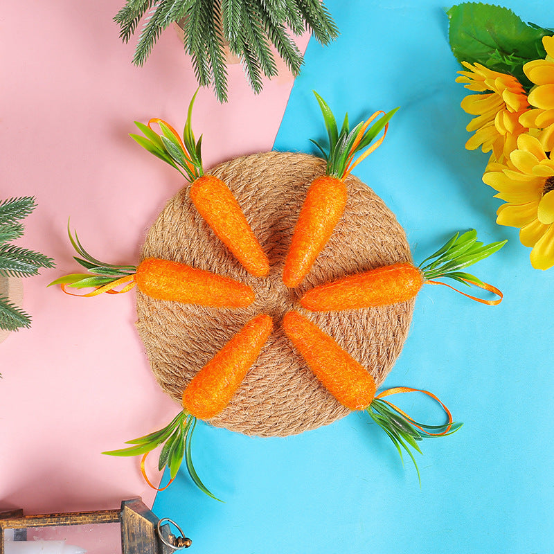 Six artificial carrots arranged in a circular pattern on a woven mat, featuring bright orange color and green leaves.