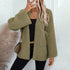 Side view of oversized olive cardigan with textured chevron pattern, worn with black outfit and brown crossbody bag