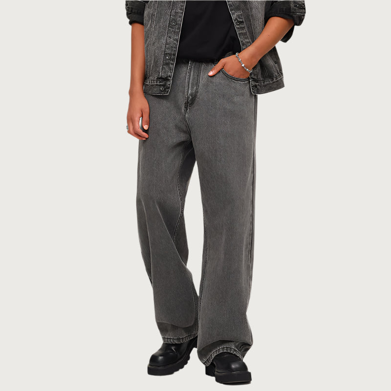 Charcoal grey wide-leg jeans styled with black combat boots and denim jacket, showcasing modern streetwear silhouette