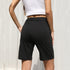 Back view of black bermuda shorts, showcasing relaxed fit and elasticated design