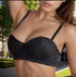 Black lace bra styled outdoors – A balconette lace bra with adjustable straps, worn in an elegant outdoor setting