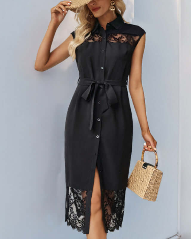 Model in a black lace-trim midi shirt dress with a waist tie and button front, accessorized with a straw handbag and gold earrings.