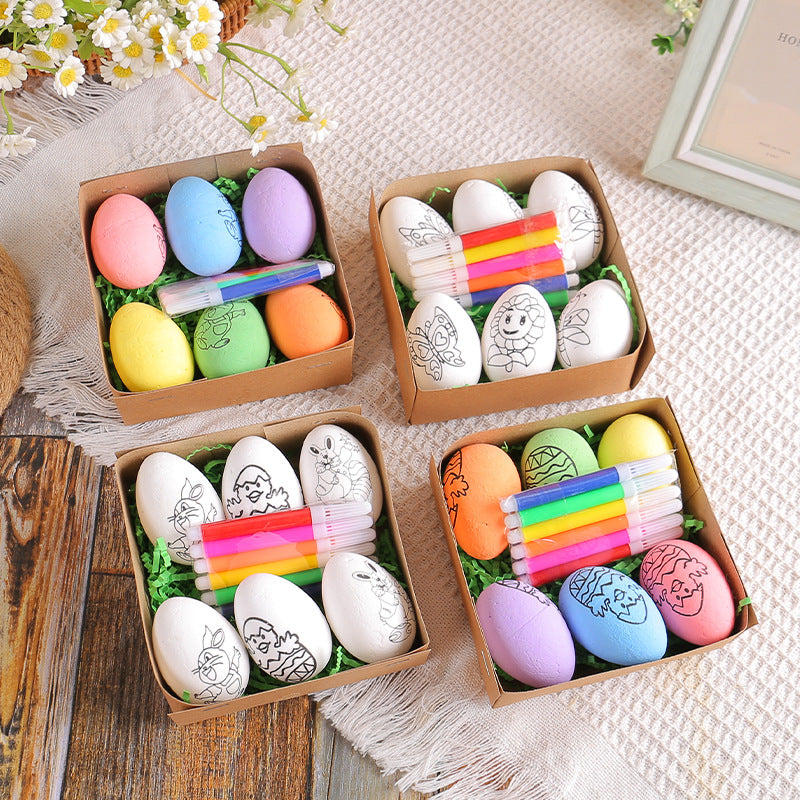 Four gift boxes with Easter egg painting kits, including colorful eggs, white eggs with printed designs, and a set of markers.