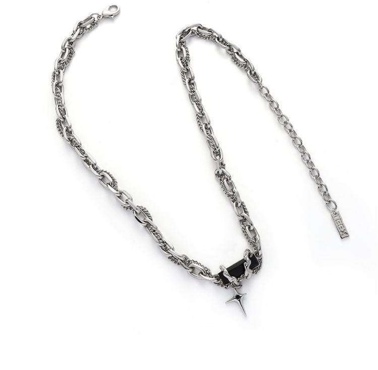 Product photo of silver chain necklace laid flat with star charm