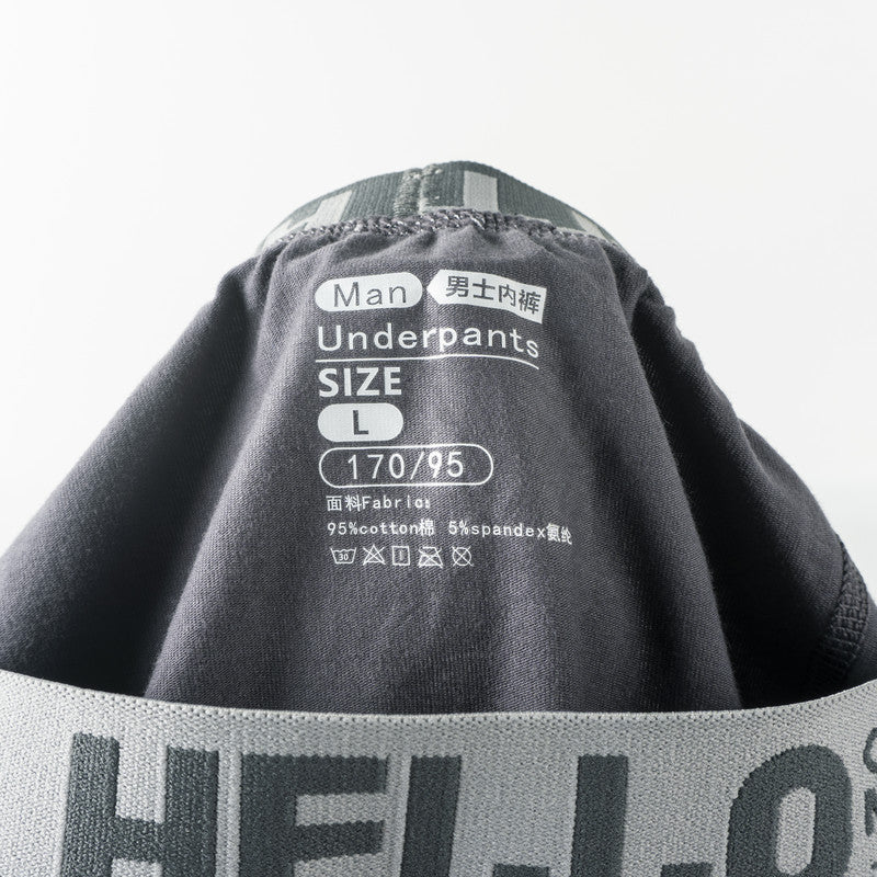 Close-up of men's underwear tag showing 'Man' label, size L (170/95), and 95% cotton 5% spandex fabric composition