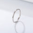 A silver sterling 925 stamped minimalist ring band displayed at angle on white background