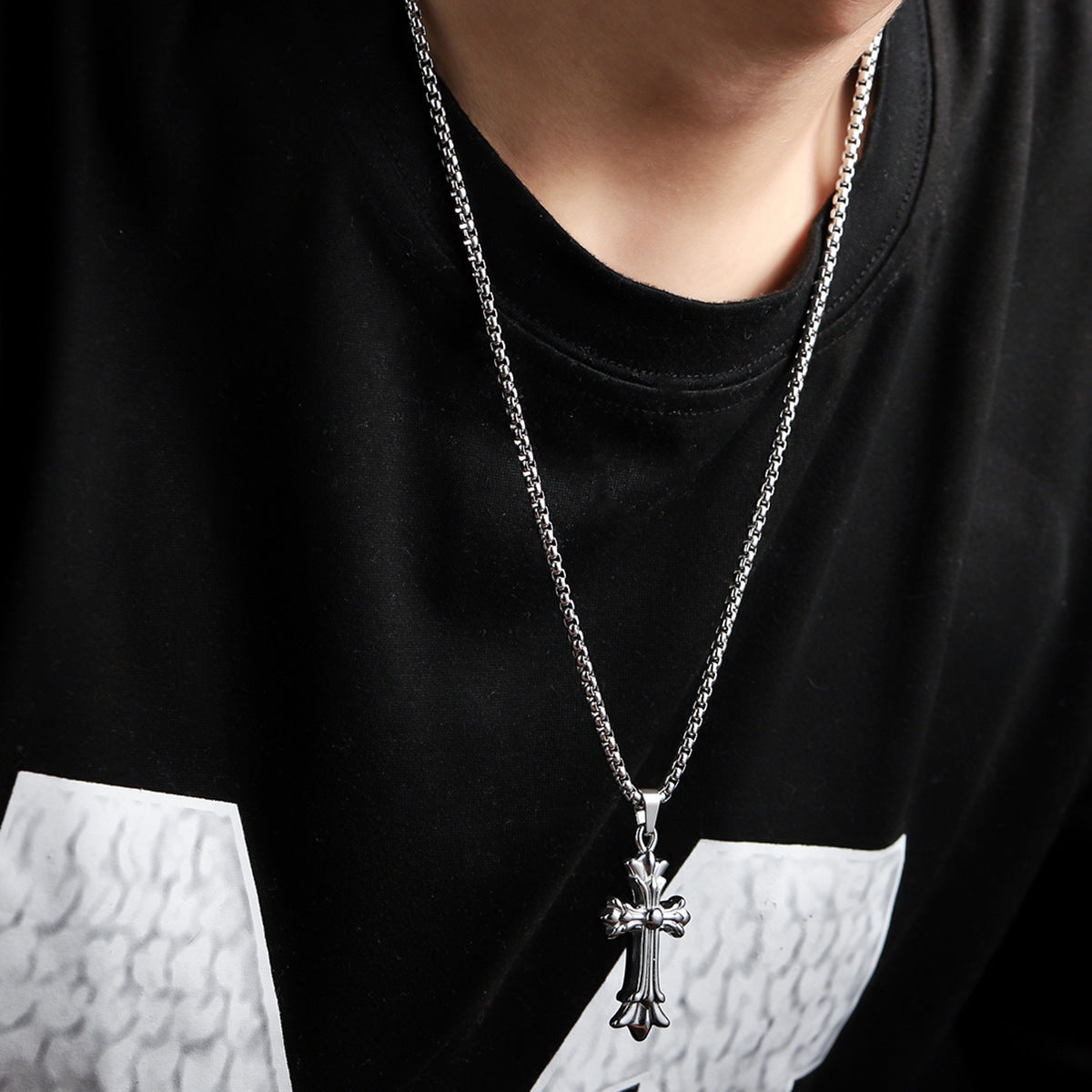 Titanium Steel box chain necklace with ornate cross pendant, styled with black t-shirt