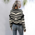 Zebra stripe cardigan, ripped jeans, side view, blonde ponytail