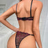 A model shows back view of black and pink lace lingerie set with adjustable straps against white bedroom backdrop