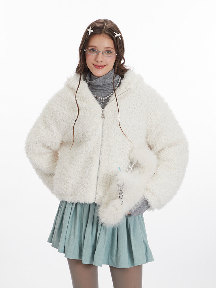 White faux fur jacket over gray turtleneck, accessorized with pearl necklace and matching sage skirt