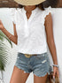 Close-up of model in white embroidered blouse with ruffle sleeves and button-up front, accessorized with gold jewelry and bracelets.