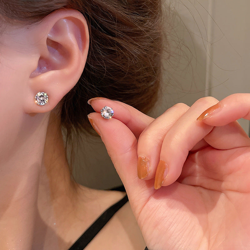 Cubic zirconia earrings showing size progression on ear