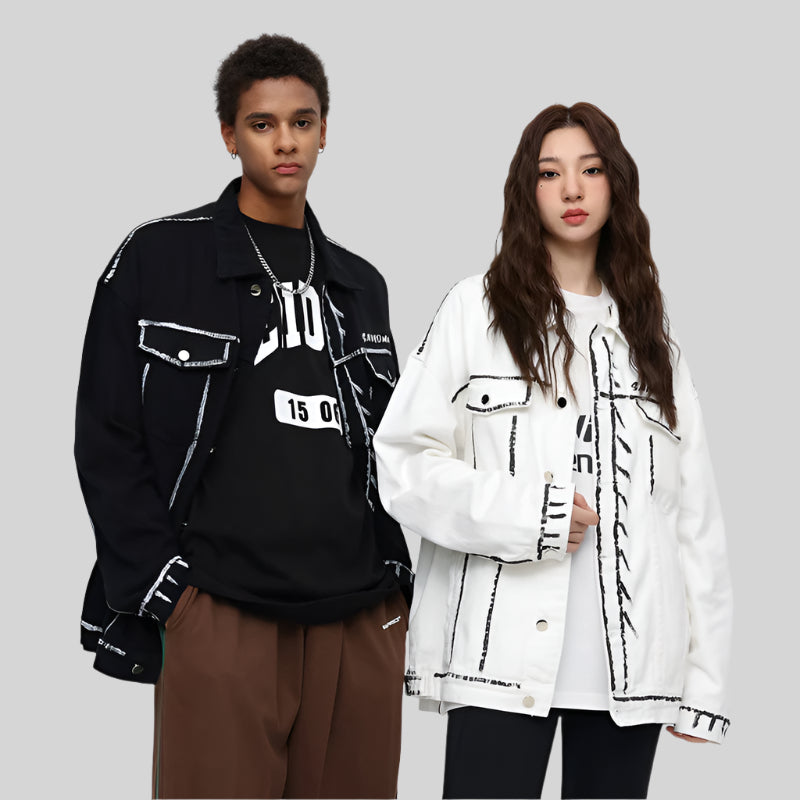 A man and woman are standing against a gray background. Both wearing SANHOMME outline denim jackets in black and white with contrast stitching