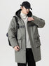 A man wearing olive NEIGHBORHOOD parka with black hood carries a backpack while standing against white background in complete outfit
