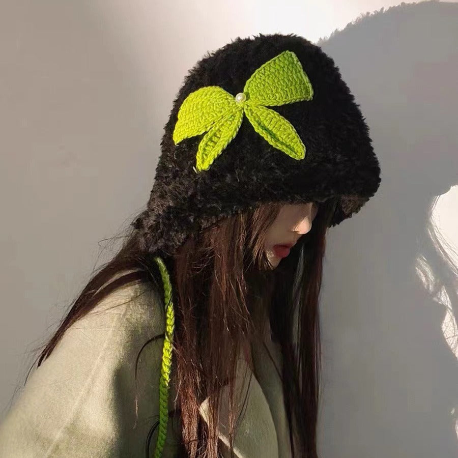 Black fluffy winter hat featuring bright lime green crochet bow and matching green braided cord