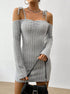 Close-up of a gray off-shoulder mini dress with tie straps and a ruched bust, accessorized with rings and a handbag