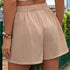 Side view of beige elastic-waist skort with gathered fabric detail, showcasing summer-ready casual style