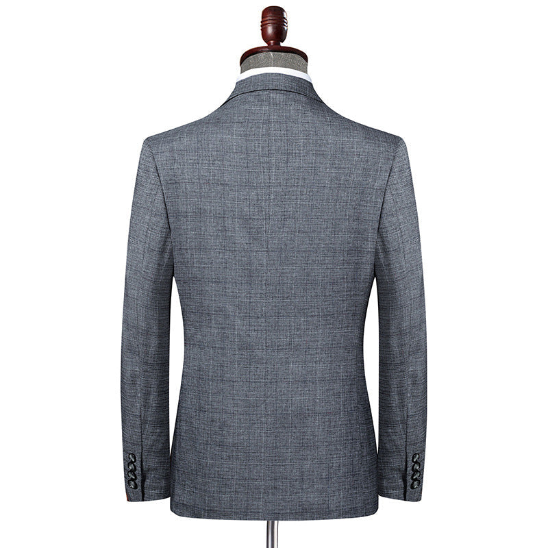 Back view of tailored gray suit jacket on display form showing clean lines and structured shoulders