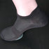 Black ankle sock displayed on mannequin foot showing breathable mesh construction and ribbed elastic cuff against dark background