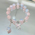 Rose quartz and opal-like beaded bracelet with crystal butterfly charm and hanging bead detail