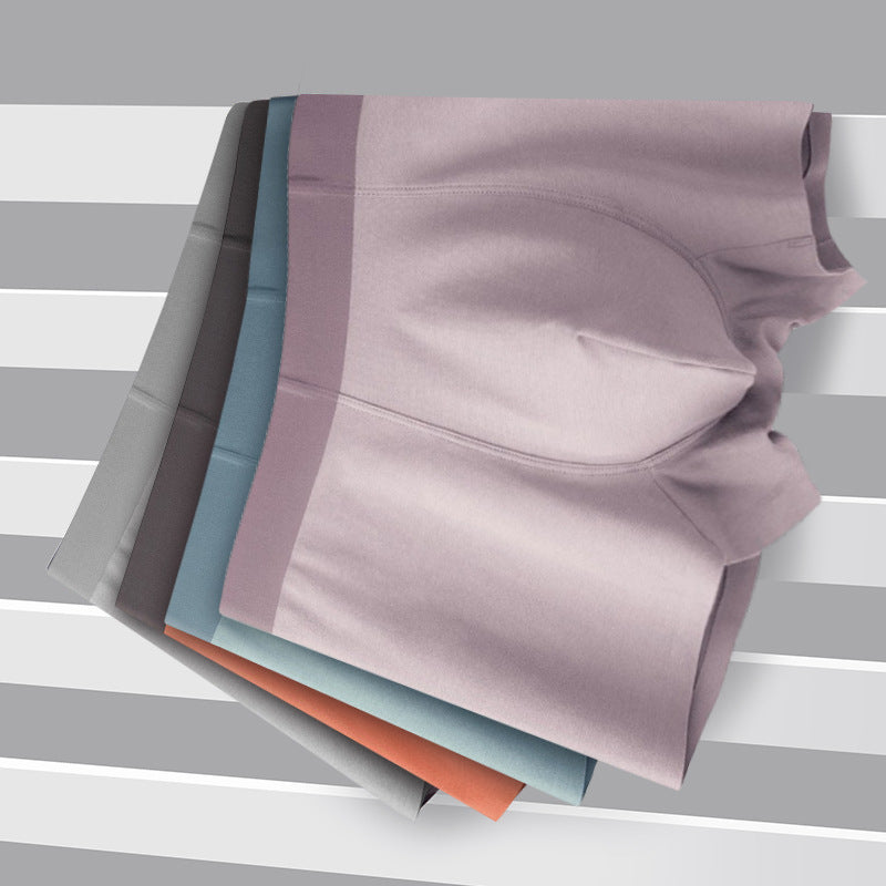 Folded boxer briefs in multiple muted colors including gray, blue, and salmon, displayed on striped background