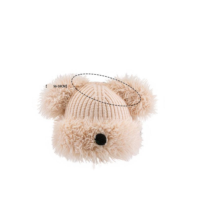 Close-up of beige Dog Nose Plush Knit Beanie with size measurement 56-58CM, showing detailed knit pattern and furry texture