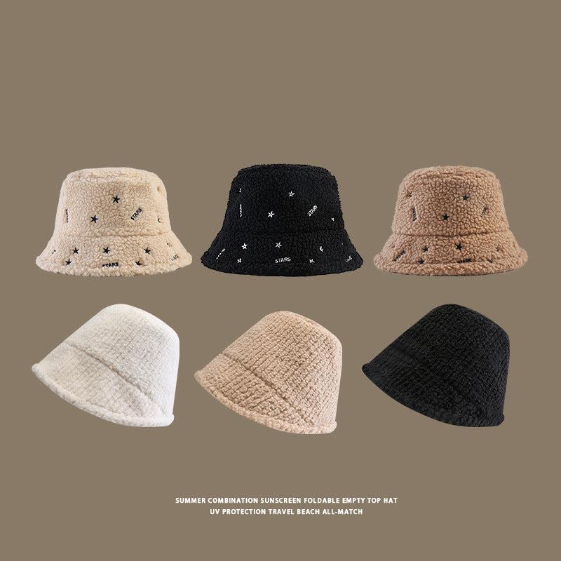 Collection of six teddy bucket hats displayed in ivory, black and beige colors with star embroidery and plain designs against taupe background