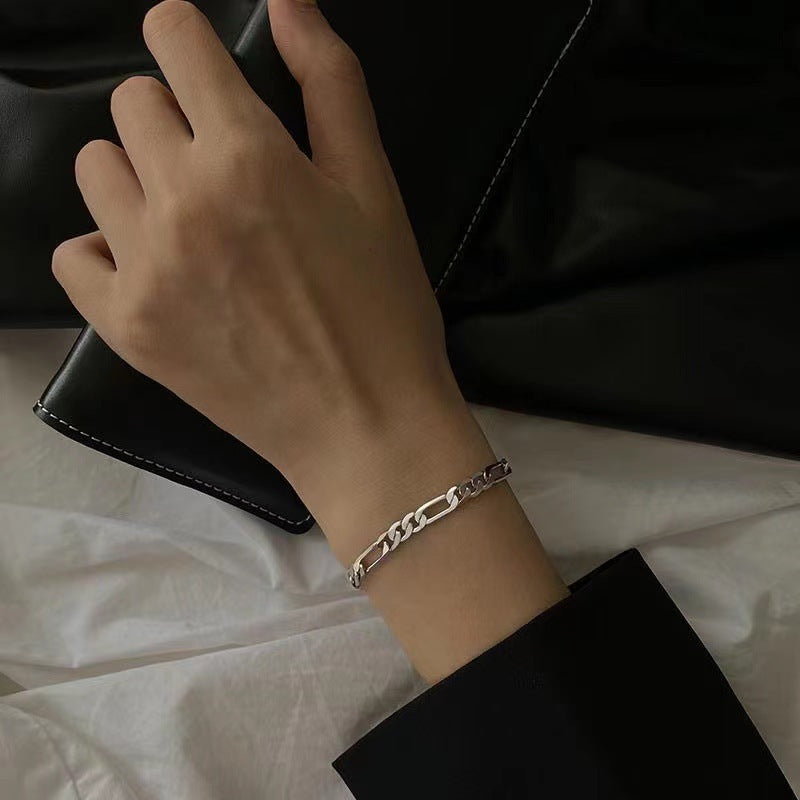 Elegant silver Figaro chain bracelet on hand