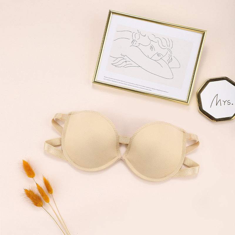 Nude beige strapless bra with gold-framed line art and wheat-like dried flowers