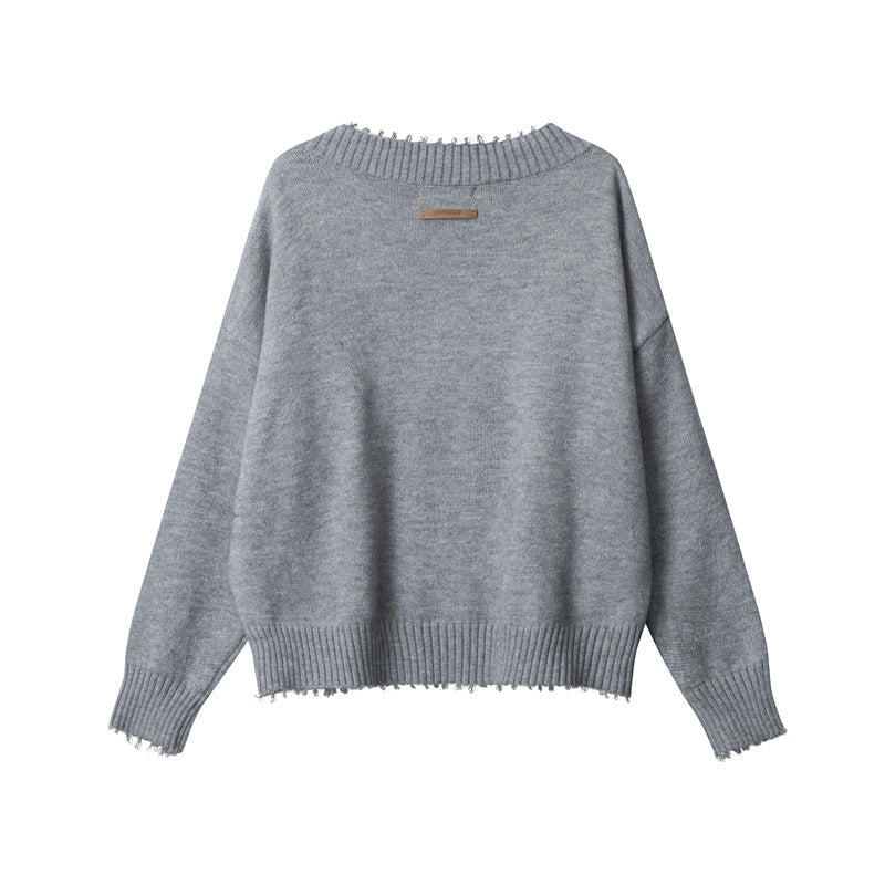 Back view of grey V-neck sweater with ribbed collar detail, distressed trim edges, and drop shoulder design