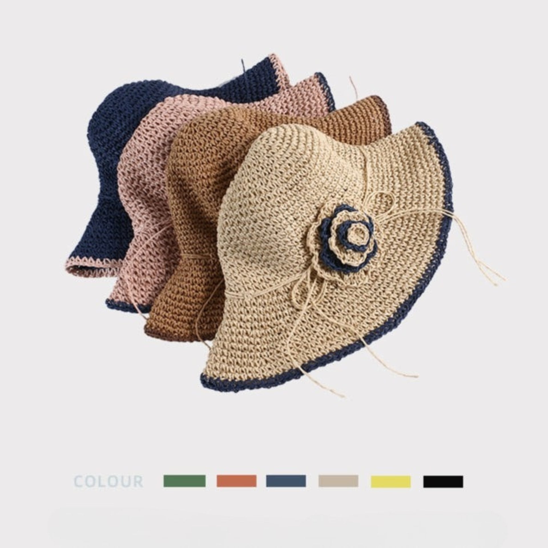 A collection of woven sun hats with floral accents in various colors, neatly stacked to showcase their flexibility and style.
