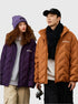 woman wearing purple quilted jacket with matching beanie and man in camel brown quilted jacket with black scarf and baseball cap